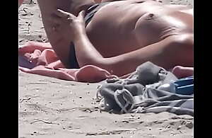 French mature sweeping on a difficulty beach -